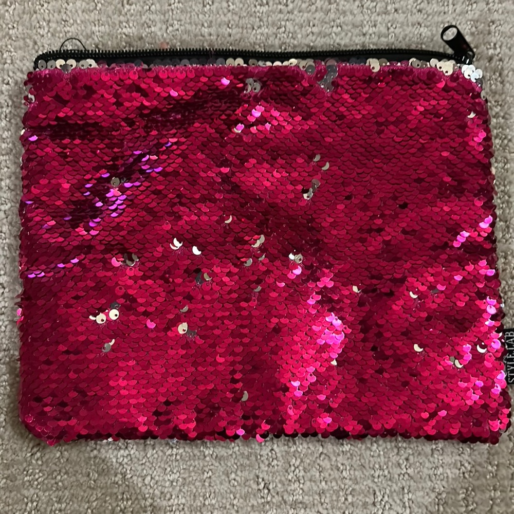 Silver and Hot pink sequin flip bag. Black lining inside the bag.